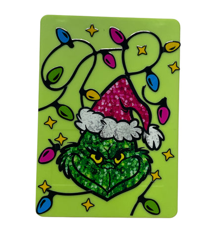 Grinch mirror with makeup brushes